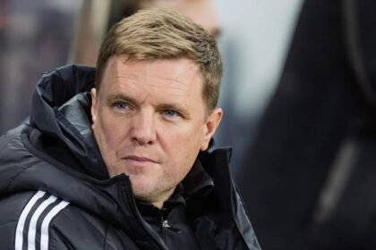 Eddie Howe looks out from a rainy dugout