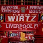 Liverpool scarves showing off new signing Florian Wirtz