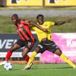 Edward Chilufya FC Midtjylland (L) and Bob Nii Armah of KuPS (R) in action during the UEFA Europa League match