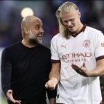 Man City manager Pep Guardiola speaks to Erling Haaland