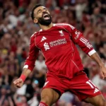 Liverpool's talisman, Mohamed Salah, has set a new Premier League record, becoming the first player in the competition’s history to score 10 goals on opening days. His remarkable feat came in a thrilling 4-2 win over Bournemouth at Anfield on Friday. A Historic Achievement Salah's strike, which came in injury time to seal the victory for Arne Slot’s side, was not just the match-winner but also a milestone that further cements his legendary status. The goal marked his 10th opening day goal, a record that no player has previously reached. Salah was already the most prolific scorer on the first day of the Premier League season, but this double-digit tally takes him into uncharted territory. Four other Premier League greats have scored eight goals on opening day, including Wayne Rooney, Alan Shearer, Jamie Vardy, and Frank Lampard. But it’s Salah who now stands alone at the top of this particular list. More Milestones for Salah In addition to his record-breaking opening day tally, the Egyptian forward also reached 187 goals in the Premier League, pulling level with Andy Cole in fourth place on the all-time top scorers list. His continued consistency in front of goal is nothing short of extraordinary, and it’s clear that he remains one of the best in the business. A Night of Emotion Friday’s match was charged with emotion, as Liverpool also paid tribute to Diogo Jota, who tragically lost his brother earlier in the week. The Kop crowd sang Jota's name throughout the match, and Salah was visibly moved as the team dedicated the win to the late Portugal international. What’s Next for Salah and Liverpool? With another goal to his name, Salah will be looking to add to his tally in Liverpool’s next match against Newcastle. The Reds have started the season with a dramatic win, and with Salah’s history-making form, they’ll be aiming to continue their push for the title.