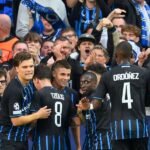 Nicolò Tresoldi celebrates with teammates after opening the scoring for Club Brugge