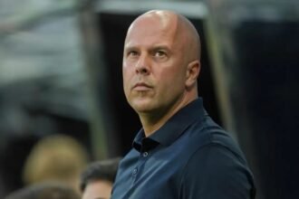 Arne Slot looks up during a Premier League match.