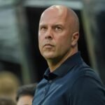 Arne Slot looks up during a Premier League match.