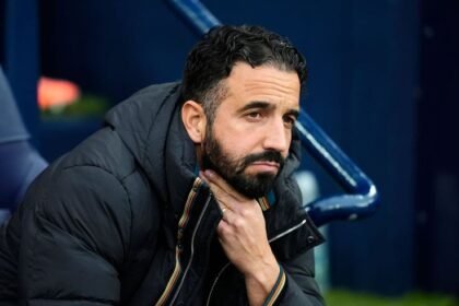 Ruben Amorim looks concerned on the sidelines during a match.