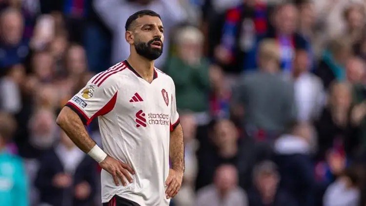 Mohamed Salah puts his hands on his hips during a Premier League match.