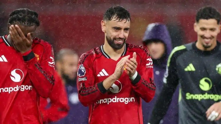 Bruno Fernandes applauds Man Utd fans.