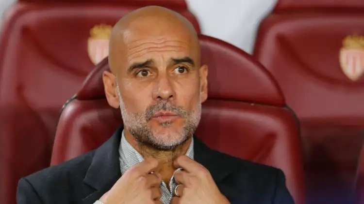 Pep Guardiola on the bench for Manchester City.