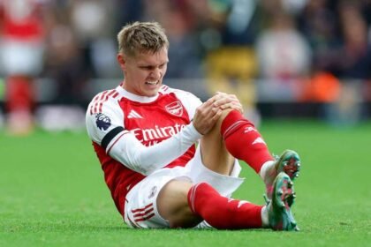 Martin Odegaard reacts after the injury