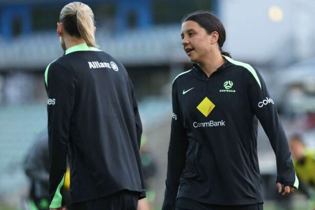 Sam Kerr speaks with Emily van Egmond (left) at a Matildas training session.